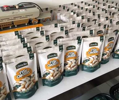 Sealed Qisbelin Fish Crackers pouches on the packing table